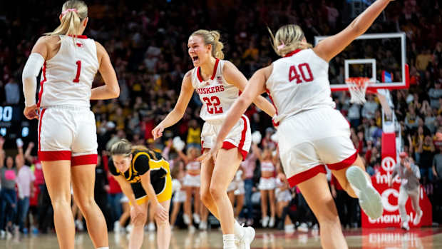 Nebraska's Natalie Potts runs to her teammates after defeating Iowa 82-79 Sunday, Feb. 11, 2024, at Pinnacle Bank Arena.